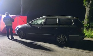 policjantka zabezpiecza samochód uczestniczący w wypadku