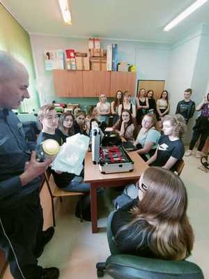 policjant pokazuje sposób zabezpieczenia śladów.