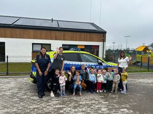widzimy wspólne dzieci z policjantkami na tle policyjnego radiowozu.
