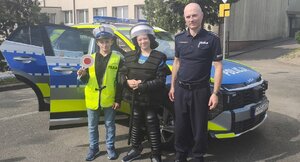 widzimy policjanta z odwiedzającymi stanowisko dziećmi.